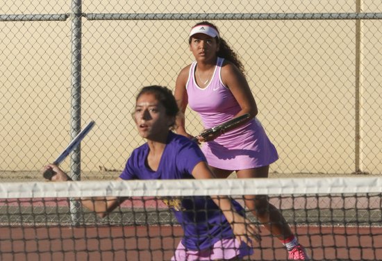 Maddie Kuntz at the net with partner Serena Mendoza won their doubles match Wednesday against West Bakersfield.
